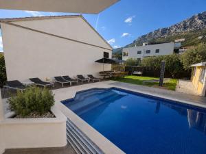 a swimming pool in the backyard of a house at Villa Rocco Private Saltwater Pool Split in Kaštela