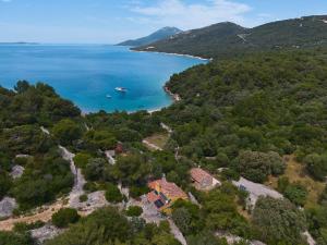 an aerial view of a house and the ocean at Lošinj house Robinzon Studenčić Island Lošinj in Čunski