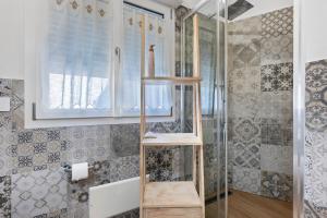a shower with a wooden shelf in a bathroom at Lu Furru Apartments in Telti +31 photos