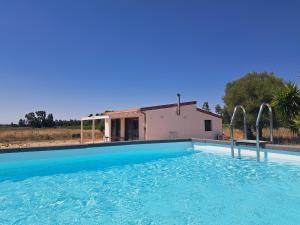 a swimming pool in front of a house at pura natura Alghero in Alghero +52 photos