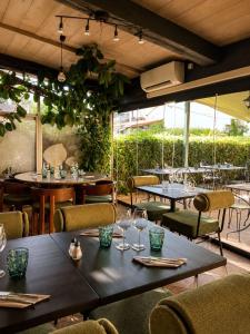 a restaurant with tables and chairs and windows at L'Imprevisto in Grasse