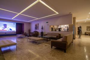 a large living room with couches and a projection screen at Afrin Prestige Hotel in Maputo
