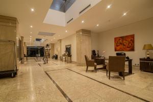 a large living room with a table and chairs at Afrin Prestige Hotel in Maputo +112 photos