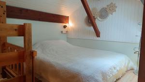 a bedroom with a bunk bed with a ladder at Le chalet des paons - Le Mond'idéal in Felon