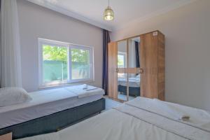 a bedroom with two beds and a window at Villa Ata Park Ortaca in Ortaca +22 photos