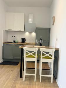 a kitchen with a table and two stools at Studio Sanja in Vlašići