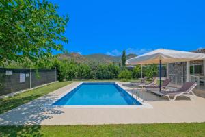 a swimming pool with two chairs and an umbrella at Villa Ata Park Ortaca in Ortaca