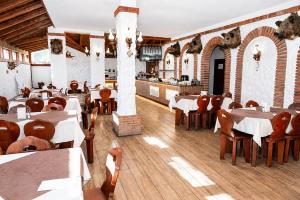 a restaurant with tables and chairs in a room at Hotel M2 in Primorsko