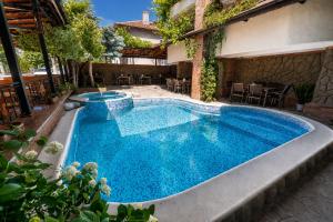 a swimming pool in the middle of a house at Hotel M2 in Primorsko