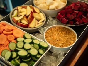 a tray filled with different types of fruits and vegetables at Radisson RED Campinas in Campinas