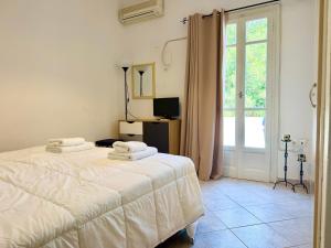 a bedroom with two beds and a window at Anemochadi in Agios Sostis