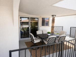 a porch with a table and chairs on a balcony at Moovalya Keys Vacation Home in Parker