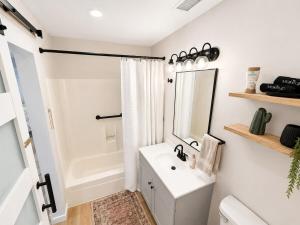 a white bathroom with a sink and a mirror at Moovalya Keys Vacation Home in Parker +12 photos