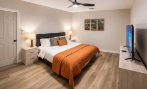 a bedroom with a bed and a flat screen tv at Moovalya Keys Vacation Home in Parker