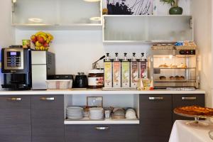 a kitchen with a counter with a coffee maker and food at Cameras Mori in Mori