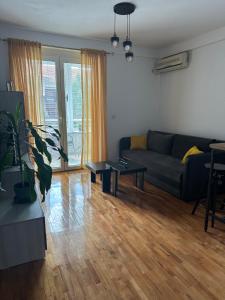 a living room with a couch and a table at Zen Apartment in Kumanovo
