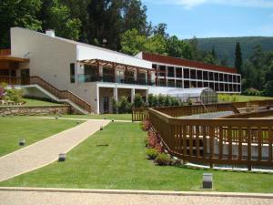 a large building with a staircase in front of it at Hotel Rural Vale Do Rio in Oliveira de Azemeis