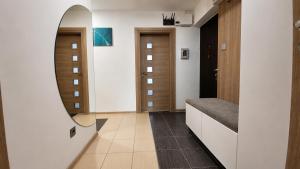 a hallway with a mirror and a dressing room at Bytča Central Apartment in Bytca