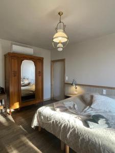 a bedroom with a bed and a large mirror at A la terre ferme in Arnac-la-Poste +121 photos