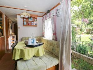 a living room with a table and a couch at 10 Cater Gardens in Guildford