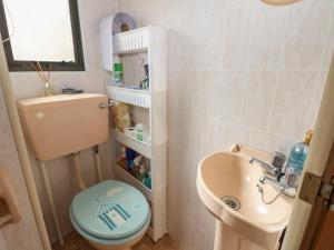 a small bathroom with a toilet and a sink at 10 Cater Gardens in Guildford