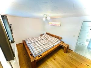 a bedroom with a bed with a checkered blanket at Ferienwohnung Kleinwalsertal in Hirschegg