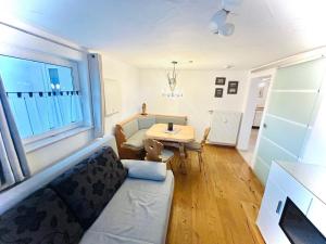a living room with a couch and a table at Ferienwohnung Kleinwalsertal in Hirschegg