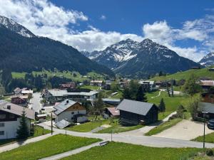 a small town in the mountains with snow covered mountains at Ferienwohnung Kleinwalsertal in Hirschegg