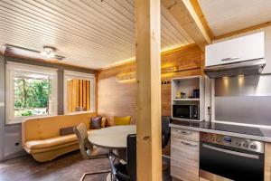 a kitchen with a table and a dining room at Ferienhaus 203 in Zadelsdorf