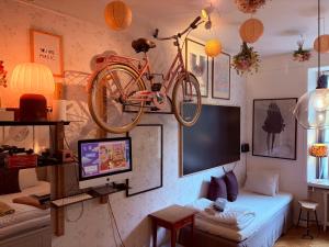 a living room with a bike hanging on the wall at OW, by A&J - Familj & Bilen & Hunden - Liseberg & Avenyn! in Gothenburg