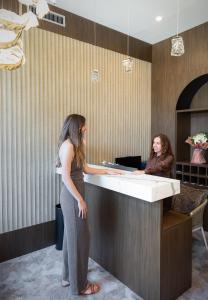 two women standing at a counter in an office at Boutique Hotel Solterra - Crikvenica in Crikvenica