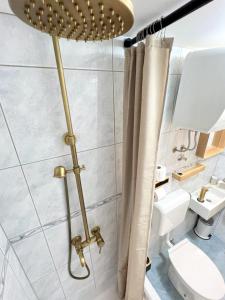 a bathroom with a shower curtain and a toilet at Casa Bella Holiday Home Rab in Rab +60 photos