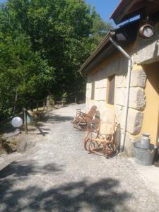 a group of chairs sitting outside of a building at Valley Cabril Selvagem in Cabril