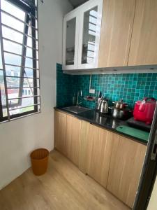 a kitchen with a sink and a counter top at Little House Đông Tác in Hanoi