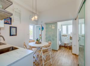 a kitchen and dining room with a table and chairs at Apartment Matoš in Omiš