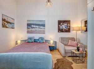 a bedroom with a large bed and a couch at Apartment Matoš in Omiš