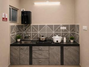 a kitchen with a counter with a sink and a stove at Goan Casa Feliz in Calangute