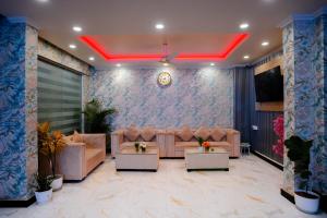 a living room with couches and a red ceiling at Hotel octavia in Imphal