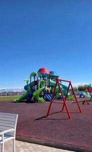 a park with a playground with a slide at Alpha White in Koshkolʼ