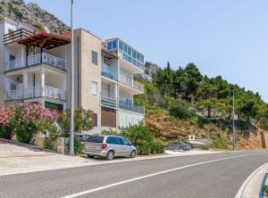 a car parked on the side of a street next to a building at Apartment Matoš in Omiš