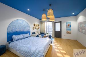 a bedroom with a bed with a blue ceiling at Little House Đông Tác in Hanoi +22 photos