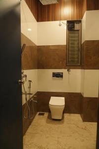 a bathroom with a toilet and a shower at Hotel Orbit in Parbhani +179 photos