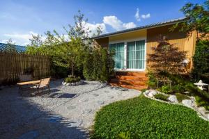 a backyard with a bench and a fence at After Beach House Phla Resort in U-Tapao