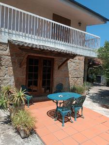 a patio with a table and chairs in front of a house at Casa da Corredoura in Penafiel