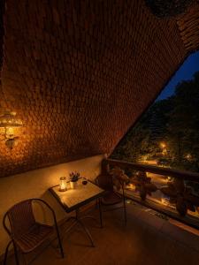 a table and chairs on a balcony at night at Dworek w Karpaczu in Karpacz