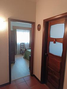 an open door to a room with a bedroom at Casa da Corredoura in Penafiel