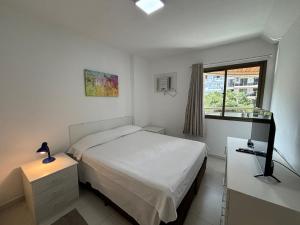 a small bedroom with a bed and a window at MC FLATS IPANEMA BEACH STAR in Rio de Janeiro +53 photos