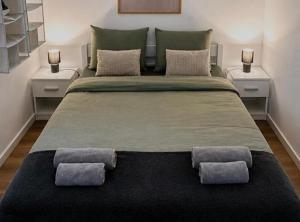 a large bed in a room with two tables and two lamps at Holiday home Damian in Zagreb +15 photos