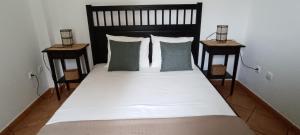 a bedroom with a large bed with two night stands at Quinta Do Pinheirão in Coruche +33 photos