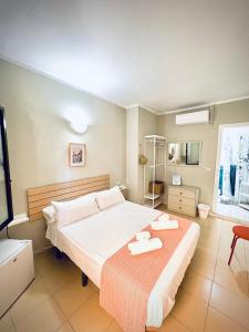 a bedroom with a bed with two towels on it at Hostal Cristina in Chipiona